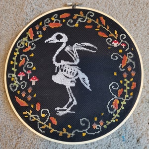Bird skeleton forest floor cross stitch
