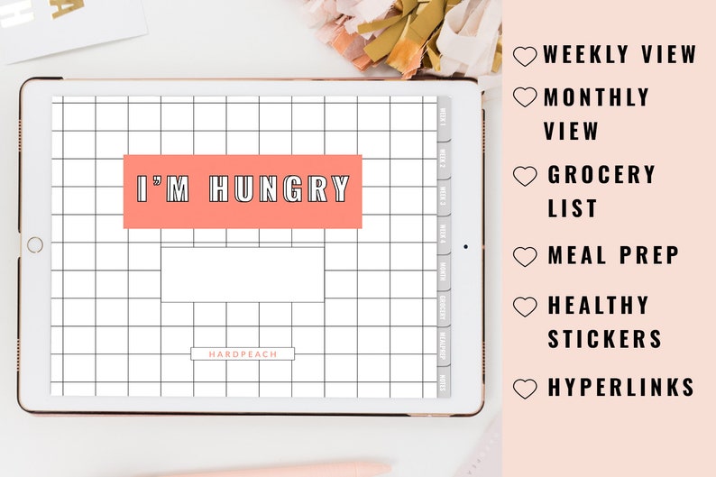 May include: A digital planner on a tablet with a pink and white grid background. The text "I'M HUNGRY" is displayed in a pink box. The planner includes features such as weekly and monthly views, grocery lists, meal prep, healthy stickers, and hyperlinks.