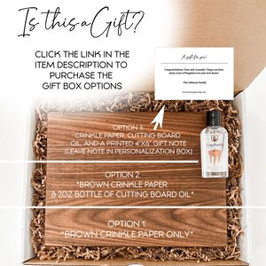 The image is a gift box containing a brown crinkle paper cutting board, a bottle of brown crinkle paper oil, and a note. The box is labeled as a gift option for purchase, and there is a note indicating that the gift is for Tony and Amanda, who have many years of happiness in their new home.