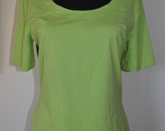 May include: A light green short-sleeved t-shirt with a scoop neck.
