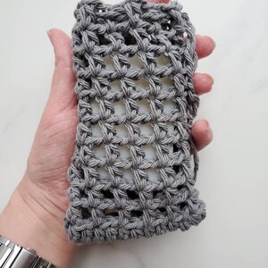 May include: Gray crocheted soap saver with a grid pattern.