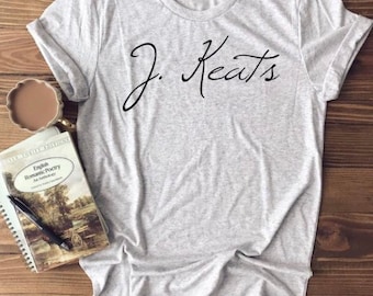May include: A gray t-shirt with the text "J. Keats" written in black cursive script.