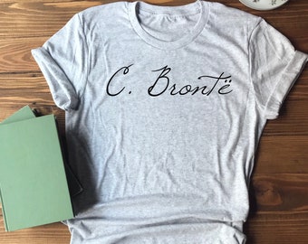 May include: A gray t-shirt with the text "C. Brontë" in black cursive writing.