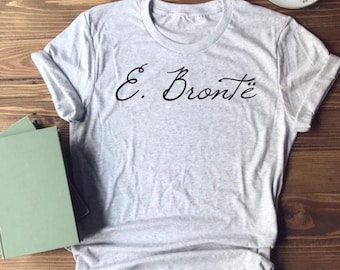 May include: A gray t-shirt with the text "E. Brontë" in black cursive writing.