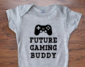May include: A gray baby onesie with a black video game controller graphic and the text "FUTURE GAMING BUDDY".