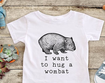 May include: White baby onesie with a black and white illustration of a wombat and the text "I want to hug a wombat".