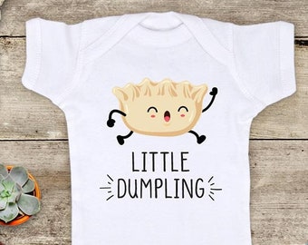May include: White baby onesie with a cartoon dumpling illustration and the text "Little Dumpling".