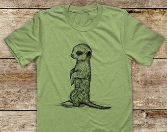 May include: A green t-shirt with a black and white illustration of a meerkat standing on its hind legs.