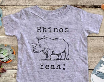 May include: A gray short-sleeved t-shirt with a black and white illustration of a rhinoceros and the text "Rhinos Yeah!"