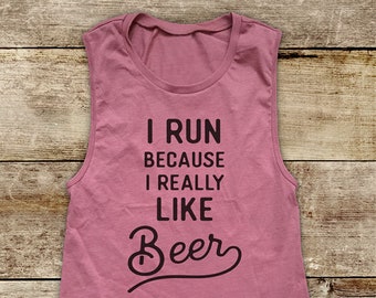 May include: A pink sleeveless tank top with the text "I run because I really like beer" printed on the front.