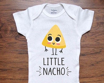 May include: White baby onesie with a yellow cartoon chip with a smiling face and the text "LITTLE NACHO" printed on it.