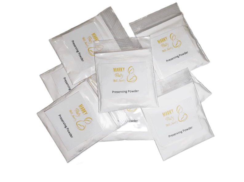 May include: Six white pouches with gold lettering that reads "MARKY Baby Milk Saver" and "Preserving Powder".