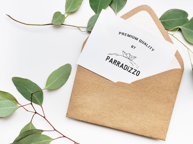 May include: A white card with the text "PREMIUM QUALITY BY PARRADIZZO" and a small illustration of a paper boat on a wave. The card is in a brown envelope.