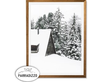 Könnte beinhalten: Ein gerahmtes Foto einer schneebedeckten Hütte, eingebettet in einen Wald aus schneebedeckten Kiefern. Die Hütte hat ein dreieckiges Dach und eine Holzaussenseite. Die Bäume sind hoch und schlank, mit schneebehangenen Ästen.