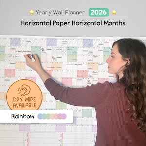 May include: A large, rainbow-coloured 2026 yearly wall planner with horizontal months. The planner is designed for dry-erase markers and features a woman writing on it. Text includes "Yearly Wall Planner 2026", "Horizontal Paper Horizontal Months", and "Dry Wipe Available".