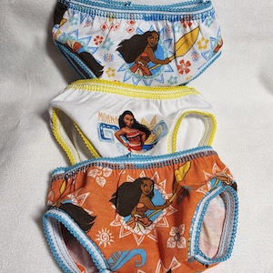 May include: Three pairs of children's underwear featuring a cartoon character. The top pair is white with blue trim, the middle pair is white with yellow trim, and the bottom pair is orange with blue trim. Each pair has a different design of the same character.