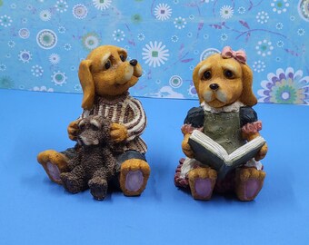 Small Resin Boy Dog Holding His Toy And Small Resin GirlDog Reading a Book 3 Inches