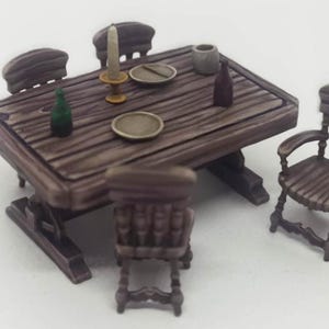 May include: A miniature wooden dining set with a rectangular table and four chairs. The table is set with plates, a candle, and bottles. The set is painted in shades of brown and is designed to look rustic.
