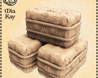 May include: Three stacked bales of hay, each wrapped in twine, are arranged in a pyramid shape. The bales are a light brown color and have a rough, textured surface.