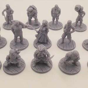 May include: A set of 14 grey 3D printed miniature figures of pirates and fantasy characters, each standing on a round base with a wood grain texture.