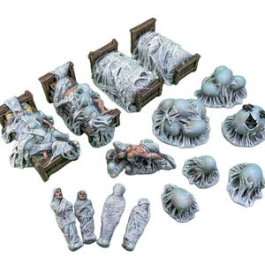 May include: A collection of miniature fantasy figurines, including beds with figures wrapped in webbing, cocoon-like formations, and mummified figures. The color palette is primarily gray and brown, with some figures lying down.