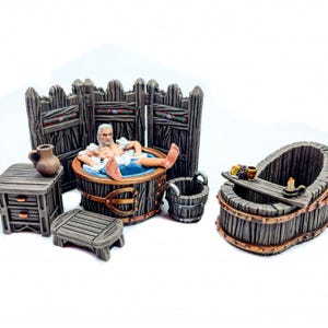 May include: A miniature wooden spa scene featuring a figure relaxing in a round tub with bubbles. The scene includes a small table, a stool, a bucket, and a second tub with a candle and fruit. The wood is a dark brown color.