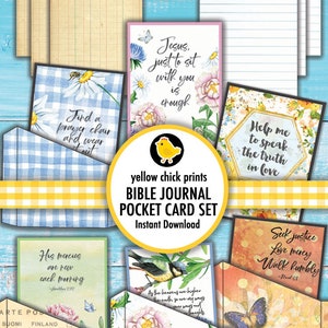 May include: A set of Bible journal pocket cards with floral and butterfly designs. The cards feature inspirational quotes and text, with a yellow chick logo and the words "BIBLE JOURNAL POCKET CARD SET". The background is a light blue wood.