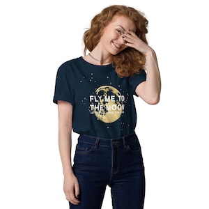 May include: A navy blue t-shirt with a gold glitter moon and stars. The text "Fly me to the moon, let's play among the stars" is printed on the shirt.