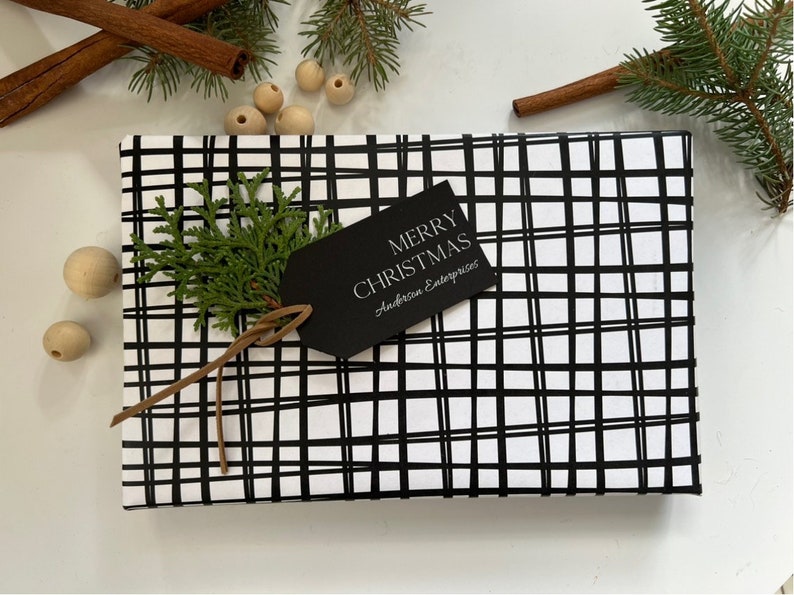 May include: Black and white plaid gift wrap with a black gift tag that says "Merry Christmas" and "Anderson Enterprises".