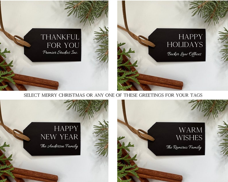 May include: Four black gift tags with white text. The tags are tied with brown twine and are displayed against a white background with sprigs of greenery. The text on the tags reads: "Thankful for you", "Happy Holidays", "Happy New Year", and "Warm Wishes".