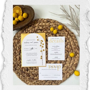 May include: A wedding invitation suite with a yellow and white color scheme. The invitation features a floral illustration and the text "Audrey and James" in a script font. The details card includes the date, time, and location of the wedding. The RSVP card has a simple design with the couple's names and a space for guests to indicate their attendance.