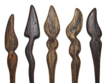 May include: Six wooden hair sticks with different designs. The sticks are all dark brown and have a natural wood finish.