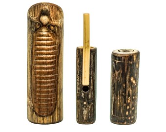 May include: Three wooden percussion instruments, two are cylindrical and one is a hollowed-out log with a carved design. The cylindrical instruments have a dark brown finish and the log has a lighter brown finish.