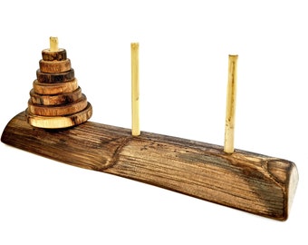 May include: A wooden puzzle game with a stack of wooden rings on a wooden base. Two wooden dowels are on either side of the base.
