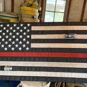 Fire Hose Flag with the thin red line. Great firefighter flag for wall art. Perfect firefighter gift or retirement gift