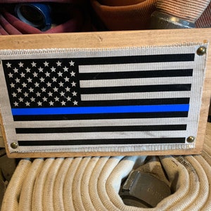 Fire Hose Sign showing  off the thin blue line with this thin blue line flag. Great gift for officer or law enforcement gift for police.