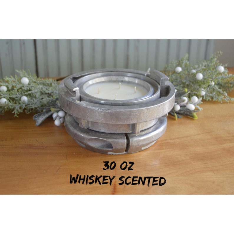 May include: A 30 ounce candle in a silver metal container shaped like a fire hose coupling. The candle is scented with whiskey.