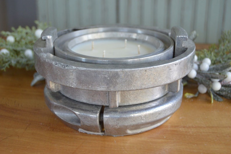 May include: A silver metal candle holder shaped like a fire hydrant with a white candle inside.