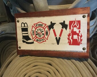 A Fire Hose Sign custom with love written by symbols. Great retirement gift, firefighter gift or a gift for dad. Perfect wall or home decor.