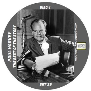 May include: A black and white photo of Paul Harvey, a radio personality, sitting at a microphone. The photo is on a CD with the text "PAUL HARVEY THE REST OF THE STORY DISC 1 SET 29" and "www.paulharveyradio.com".