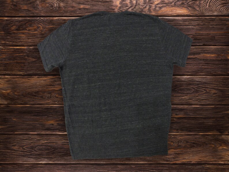 May include: A dark gray t-shirt with a plain front. The shirt is made of a soft, comfortable fabric and has a relaxed fit.