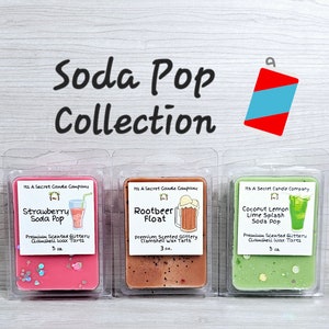 May include: Three wax melts in clear plastic containers with lids. The wax melts are pink, brown, and green. Each container has a label with the text "Its A Secret Candle Company" and the name of the scent: "Strawberry Soda Pop", "Rootbeer Float", and "Coconut Lemon Lime Splash Soda Pop".