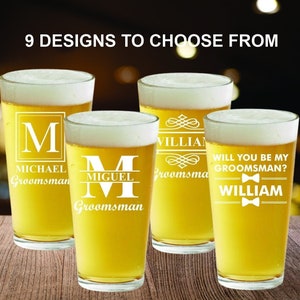 May include: Four personalized beer glasses with different designs. The glasses are filled with beer and have the text "M Michael Groomsman", "M Miguel Groomsman", "William Groomsman" and "Will you be my groomsman? William" engraved on them.