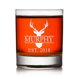 May include: A personalized whiskey glass with a deer head design and the text "MURPHY EST. 2018".