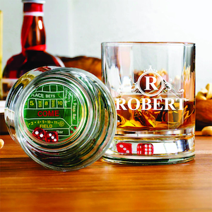 May include: Two clear glass whiskey tumblers with a green felt craps table design on the bottom of one glass. The other glass has a monogrammed "R" for Robert. Both glasses have red dice inside.