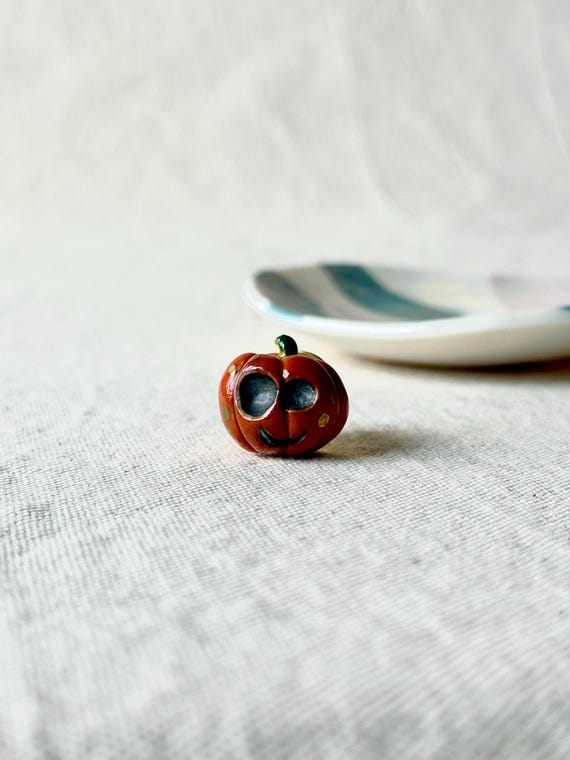 18 Halloween Accessories for a Little Everyday Spookiness 12 Porcelain Pumpkin Pin