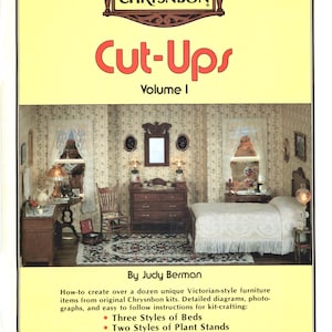 May include: A book cover for "Cut-Ups Volume I" by Judy Berman, featuring a miniature Victorian bedroom scene. The cover includes the Chrysnbon logo and lists the kit's contents: three bed styles, plant stands, a night stand, tables, and rocking chairs.