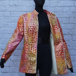 Polished cotton semi-fitted short jacket, coat. Lined . Long sleeves. Open front. Easy wear. Cream  piping. Glorious ombre sunset colors.