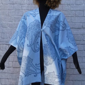 Cover up , sleeveless jacket Boho inspired paisleys on a light aquamarine ground. Button and snap closure. Washable. One size.