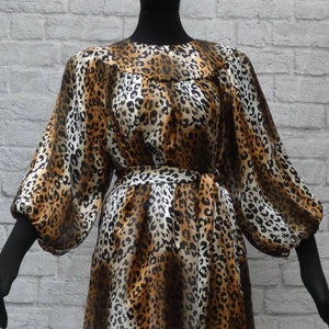 Easy breezy puffed sleeves, leopard , seasonless loosefitting silk blouse with tie belt.Jewel neckline . Button closure. Polished+packable.